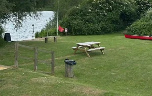 picnic bench next to lake