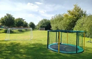 outdoor play area with trampoline